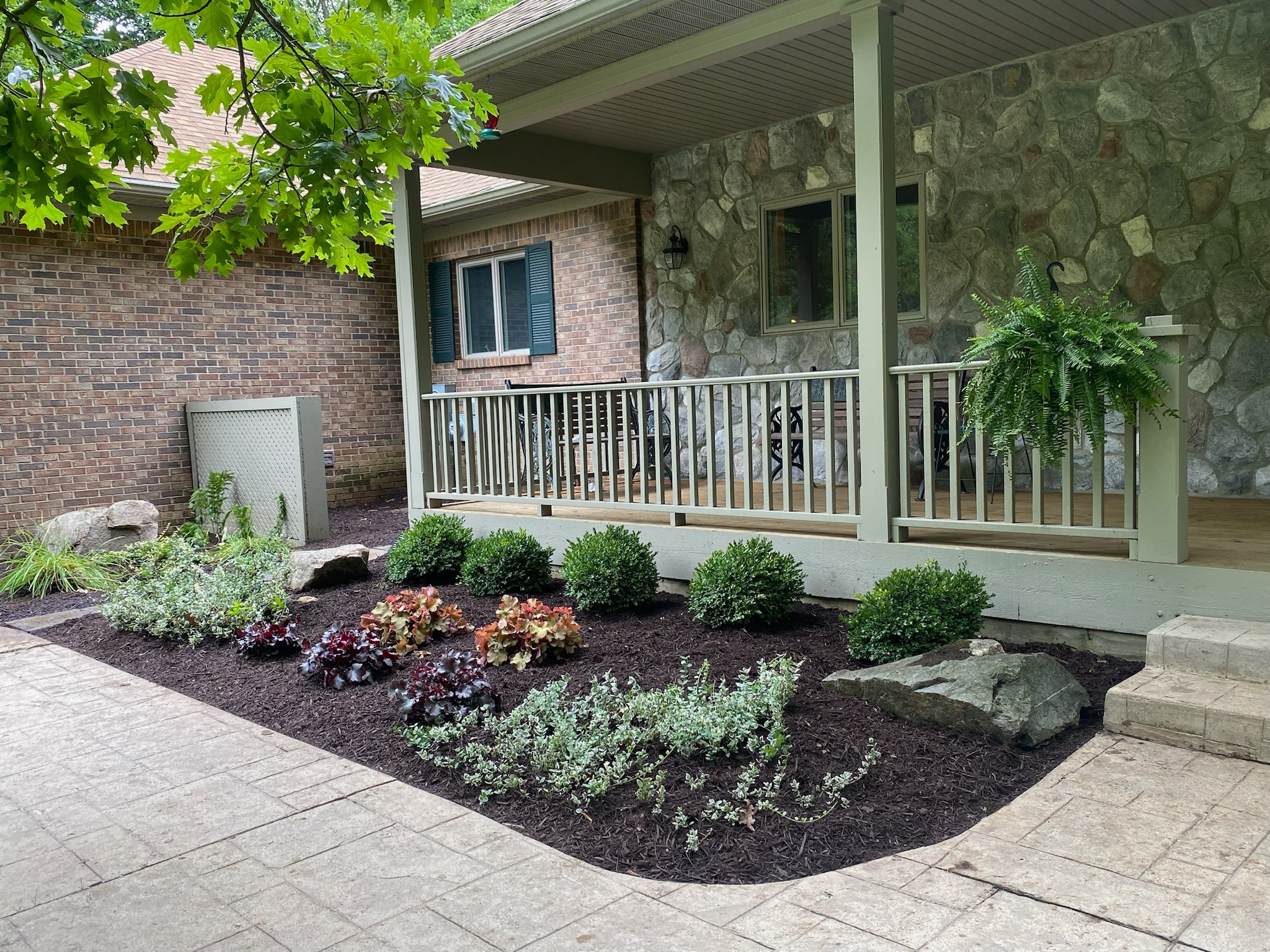 Finished landscape bed and patio area by Timberline Outdoor Services