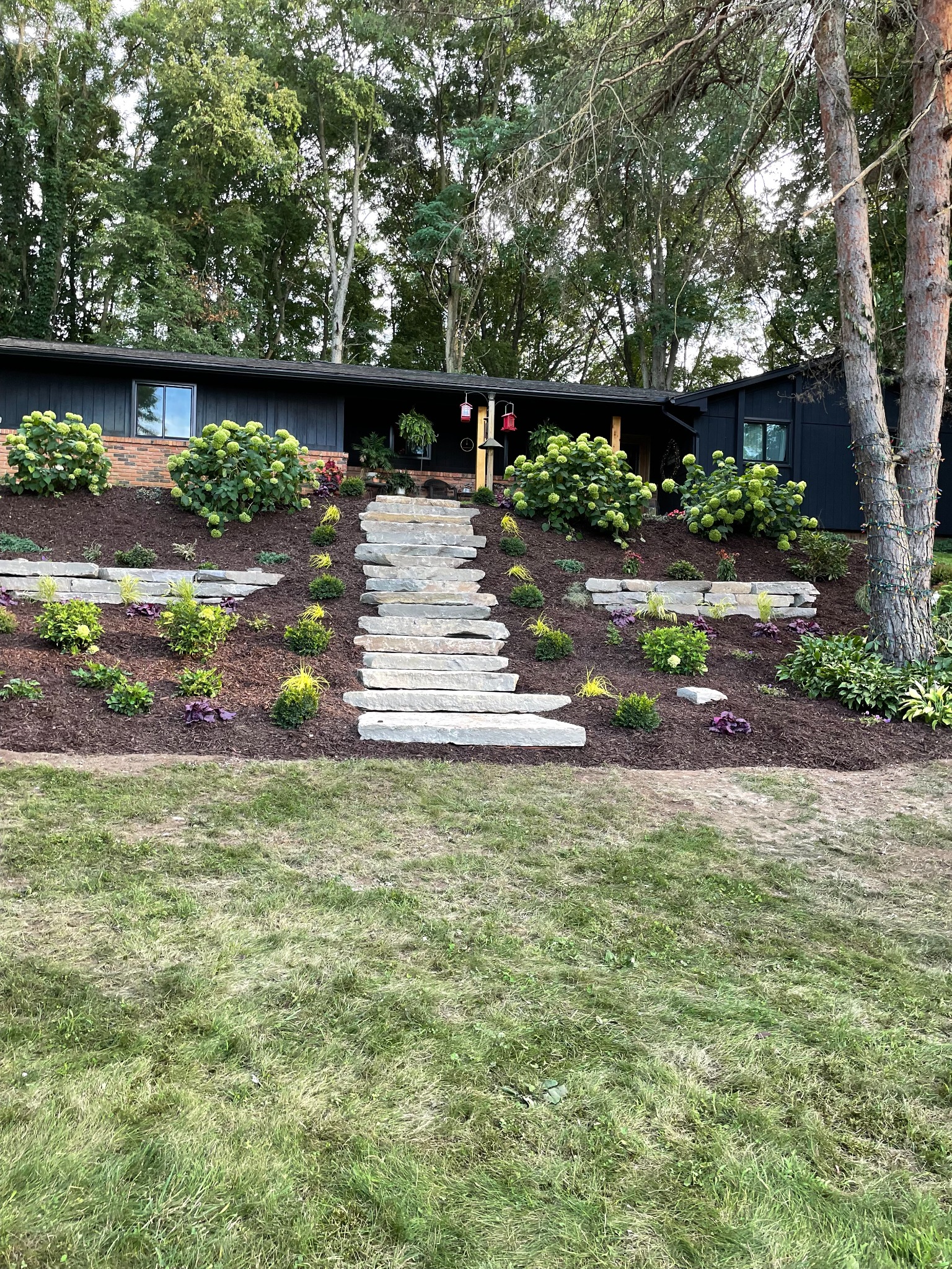 Stone steps and retaining wall landscaping by Timberline Outdoor Services